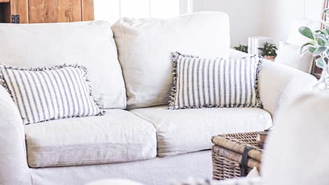 Loveseat sofa couch with white Cotton Canvas slipcover in a cozy living room