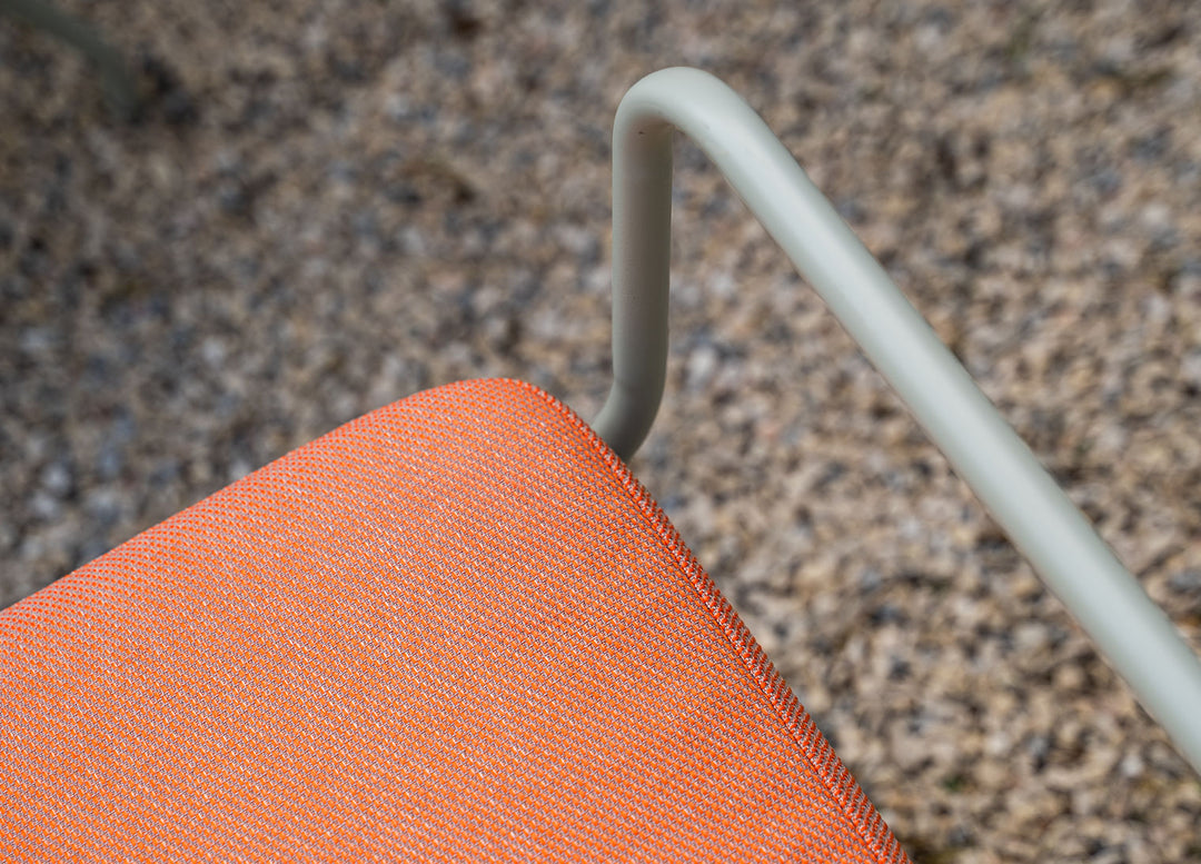 Close-up of an outdoor sofa in Performance Tweed Tangerine slipcover