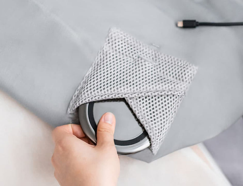 Close-up of an inner pocket with a wireless charger on the sofa smart accessories slipcover