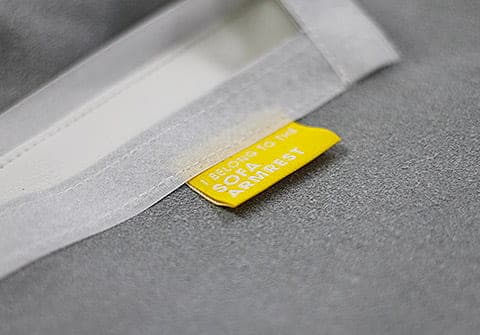 Close-up of sofa couch slipcover locator tags