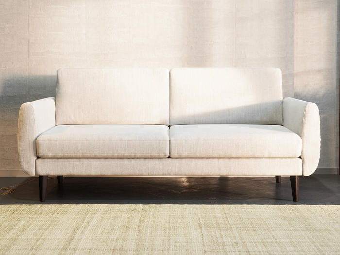 Upholstered sofa featuring a white Cotton Canvas slipcover in a cozy living room